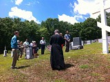 Fr. John and the faithful gather at the Cross at the center of the Parish Cemetery
