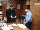 Emery shows Fr. John his prayer book.