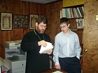 Zachary works with Fr. John on his prayer book.